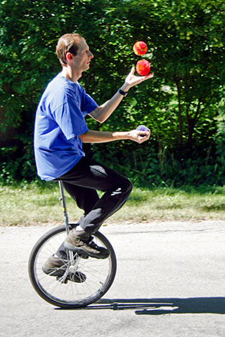 Matthew juggling while on his unicycle